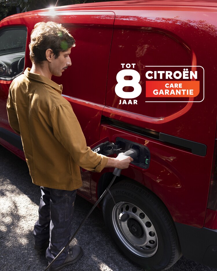 Man laadt zijn rode ë-Berlingo Van op